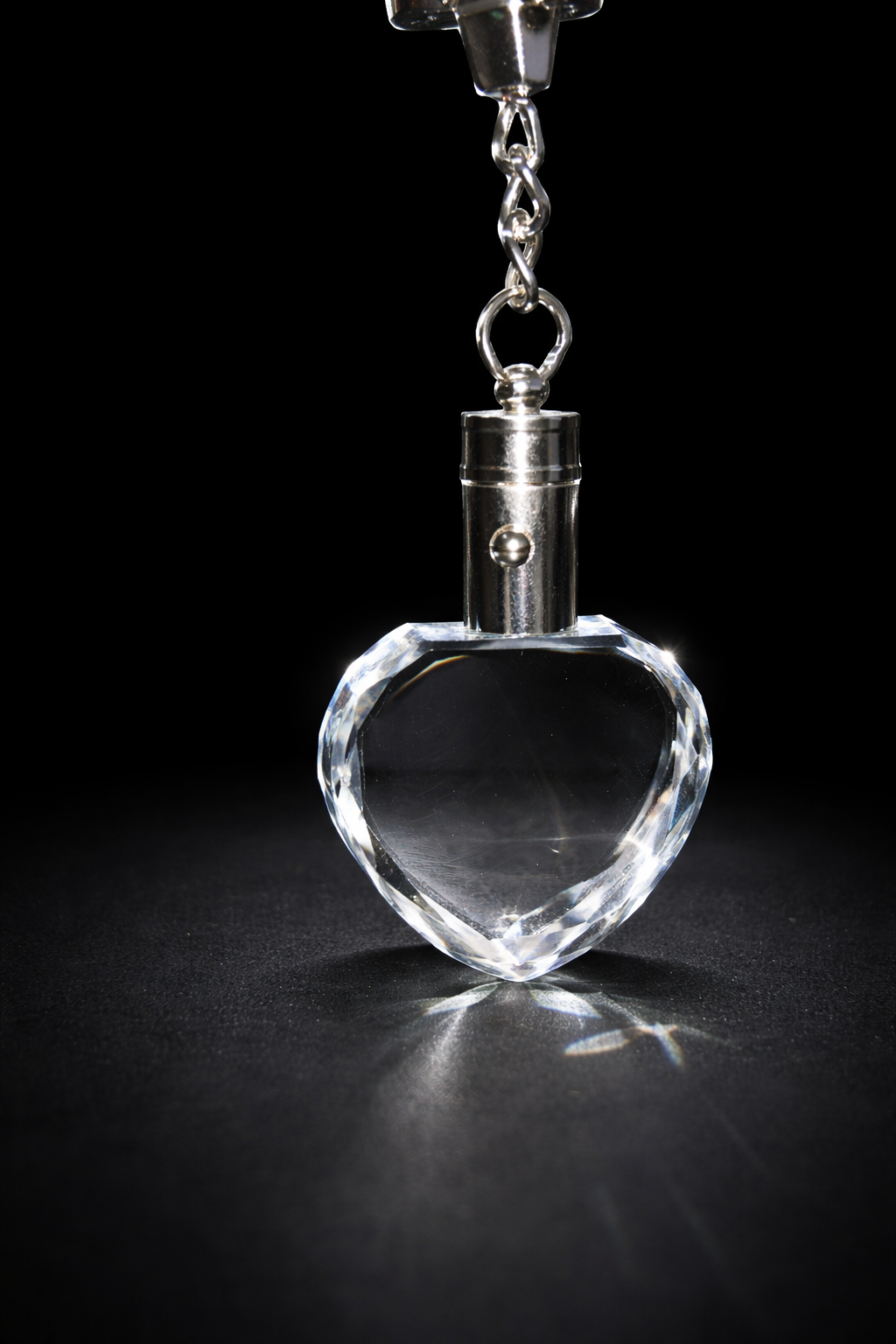 Heart-shaped crystal pendant on a black background